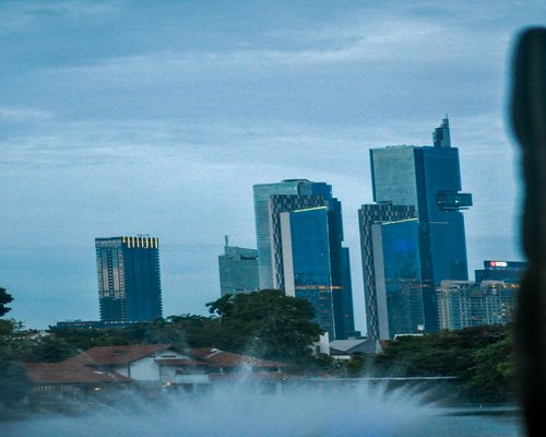 A person walking in a city park in Jakarta during early morning