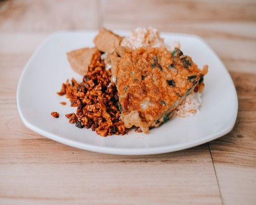 A plate of traditional Indonesian home cooked food with rice and tempeh